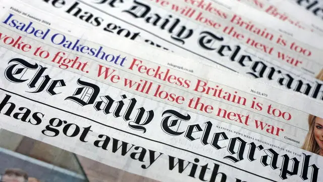 epa11106315 The Daily Telegraph newspaper at a store in London, Britain, 26 January 2024. Daily Telegraph CEO, Nick Hugh has announced he is stepping down as CEO of the Telegraph amidst a takeover bid of a UAE-backed consortium. EPA/ANDY RAIN ILLUSTRATION