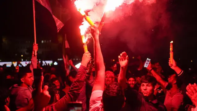 epa12101179 Syrians celebrate and set off flares following Syrian President Ahmad al-Sharaa's speech after the lifting of US sanctions on Syria, in Damascus, Syria, 14 May 2025. EPA/AHMAD FALLAHA