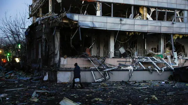 epa11889960 A person walks by the site of a Russian missile strike in Kyiv, Ukraine, 12 February 2025, amid the Russian invasion. At least one man was killed and four others, including one child, were injured in a Russian attack involving missiles and shock drones in Kyiv, according to the State Emergency Service of Ukraine (SESU). EPA/SERGEY DOLZHENKO