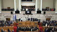 epa11960577 Constantine Tassoulas (C), flanked by Greek Prime Minister Kyriakos Mitsotakis (C-R), takes the oath of office during his swearing-in ceremony as Greece's new president at the Greek Parliament, in Athens, Greece, 13 March 2025. Former parliament speaker Tassoulas was elected by the Greek lawmakers on 12 February 2025 to succeed Katerina Sakellaropoulou as Greece's new president. EPA/GEORGE VITSARAS