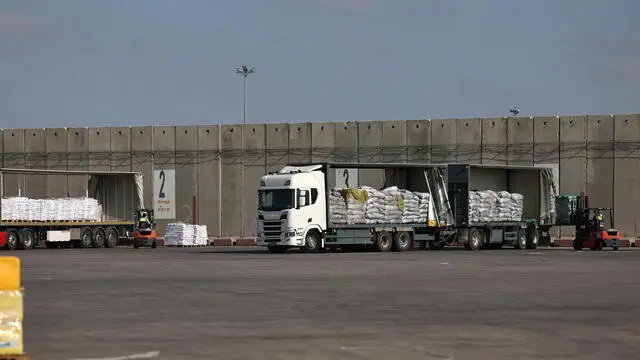 epa12124601 Trucks carrying aid wait to enter the Gaza Strip at the Kerem Shalom crossing, in southern Israel, 22 May 2025. According to the UN half a million people, or one in five people in the Strip are facing starvation while the entire population of the Gaza Strip continues to face a critical risk of famine following 19 months of conflict, mass displacement and severe restrictions on humanitarian aid. EPA/ATEF SAFADI