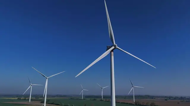 epa12066669 An image made with a drone shows an onshore wind farm in Biggleswade, Britain, 01 May 2025. The UK Environment Secretary Steve Reed said transitioning to a green economy was necessary for the UK to take back 'control of our own energy supply' especially in light of Russia's ongoing invasion of Ukraine. EPA/NEIL HALL