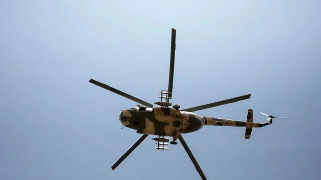 epa10804365 A Houthis-operated military helicopter flies over a neighborhood in Sana'a, Yemen, 17 August 2023. A delegation of Omani mediators has arrived in Sana'a to convince the Houthis leaders to clinch a lasting nationwide ceasefire, a day after UN special envoy for Yemen, Hans Grundberg, and the UN Security Council representatives warned of escalating attacks and public threats by Yemen's warring parties to return to war. Yemen is in its ninth year of war since the Saudi-led military coalition intervened in Yemen's conflict to restore the government after the Houthis took over the northern parts of the Arab country, including the capital Sana'a. EPA/YAHYA ARHAB