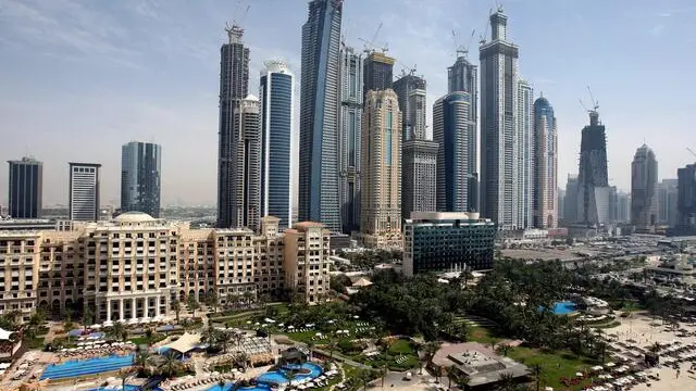 epa04629896 (FILE) A file picture dated 06 April 2010 shows a panoramic view of luxury hotels and skyscrapers at the Dubai Marina in Dubai, United Arab Emirates. A major fire was blazing in the upper floors of a skyscraper early 21 February 2015, in Dubai, with thousands of people evacuated from the building, media said. Flaming debris could be seen falling from the upper floors of the Torch, one of the tallest residential buildings in the world at 336.1 meters. The blaze began around the 50th floor and spread above the 70th floor, reports said. The building on the Dubai Marina has 79 floors. High winds were complicating the fire, and some people fleeing the building were being treated for smoke inhalation. The cause of the fire is yet unknown. No casualties have been yet reported. EPA/ALI HAIDER
