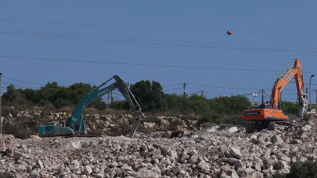 epa12127466 Israeli bulldozers near the West Bank village of Bruqin, west of Salfit, 23 May 2025. The Palestinian news agency Wafa reported that Israeli bulldozers have been levelling vast stretches of lands on the outskirts of Bruqin and Kafr ad-Dik villages. The land clearing is aimed at constructing roads and spaces to serve Israeli settlers. EPA/ALAA BADARNEH