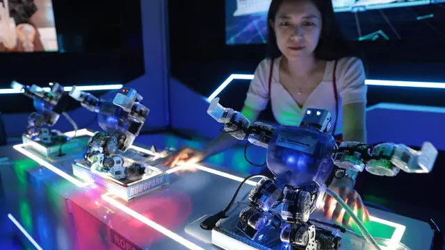 epa11435948 A visitor watches 'Dance robots' at the exhibition of a Robotic Park in Jakarta, Indonesia, 25 June 2024. The Indonesian government is encouraging progress in the field of robotics in the country in line with the rapid development of robotic technology supported by developments in artificial intelligence (AI). Indonesia has many educational institutions that teach robotics and there are even schools that put a spotlight on the field of robotics. EPA/ADI WEDA