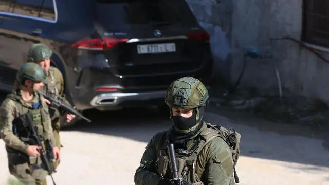 epa11756070 Israeli soldiers inspect the scene of a reported attack by Israeli settlers in the village of Huwara, near the West Bank city of Nablus, 04 December 2024. According to the Palestinian news agency Wafa, Israeli settlers set a Palestinian house and two vehicles on fire in Hawara, south of Nablus. Israel's military said that a 'violent disturbance' took place in the Huwara area, in which Israeli civilians set fire to property and threw stones. According to Israel Police, eight suspects were arrested for assaulting security forces, scuffling, and causing damage to property in the Palestinian villages of Beit Furik and Huwara overnight. EPA/ALAA BADARNEH