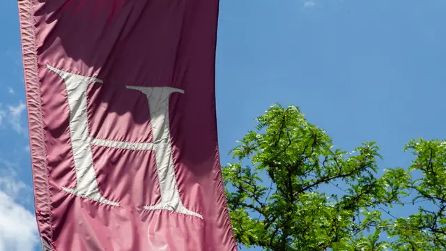 epa12139449 A large flag flies outside of the Harvard Co-op store adjacent to the Harvard University campus in Cambridge, Massachusetts, USA, 27 May 2025. US President Trump has instructed all federal agencies to terminate all federal government contracts, estimated to be 100 million dollars (88.2 million euros) with Harvard and its affiliates. EPA/CJ GUNTHER