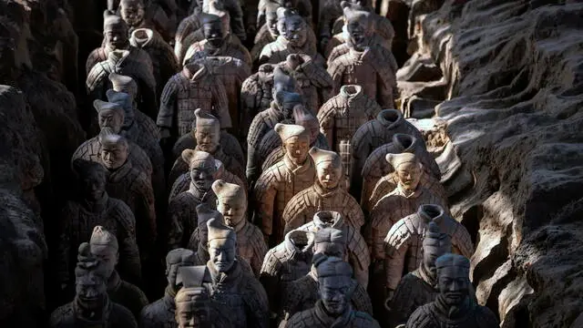 epa08154851 Terracotta Warrior statues stand on display in the Terracotta Army museum in Xi'an, Shaangxi Province, China, 19 December 2019 (issued 23 January 2020). The 2200 years old Terracotta Army is considered one of the greatest archeological discoveries of all time. Since they were first accidentally discovered by farmers in 1974 outside of Xi’an, Shaanxi, more than 8,000 warrior sculptures been excavated until today. The life-size soldiers and horses are funerary statues buried in pits near the tomb of Qin Shi Huangdi, also known as the first emperor of a unified China. Entering the biggest pit in the museum, visitors can see thousands of sculptures of warriors and horses standing in rows. Each of the statues has a different facial expression and hairstyle and craftsmen are believed to have modeled them after real men. Average height is 190cm, much taller than Chinese people would have been at that time. The most warrior statues have been found in three main pits but there are others in which non-military sculptures were discovered, including officials, acrobats, strongmen, and musicians. ‘The Terracotta Army is just a part of a much larger necropolis. Here we have more than 20 archeologists, 25 professional restorers and 60 technical staff working on restorations.’ said Lan Desheng, deputy director of the Shaanxi Ceramic Painting Cultural Relics Protection and Restauration Project Center and deputy research librarian of the Qin Shihuang Mausoleum. ‘This year, for the third time, we found more weapons such as bow and arrow, long and short swords as well as drums,’ he added. Nowadays, farmers can still find some pieces of sculptures. They must inform the Cultural Relics management office which will examine the parameter and collect the fragments. ‘It makes me excited when I finish the reparation of sculptures made of a lot of broken pieces. Like a puzzle or like a doctor who heals a patient. Once we finish the restoration of we put the sculpture
