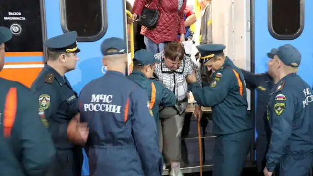 epa11539095 A handout picture made available by the Russian Emergency Ministry’s press service shows staff from the Russian Ministry of Emergency Situations assisting people evacuated from the border settlements of the Kursk region, as they arrive at a railway station in Oryol, Russia, 09 August 2024. According to Andrei Belostotsky, acting deputy governor of the Kursk region, at least four people were killed as a result of attacks by the Ukrainian Armed Forces in the Kursk region, while over 3,000 civilians were evacuated from border areas. EPA/Russian Emergencies Ministry HANDOUT HANDOUT EDITORIAL USE ONLY/NO SALESHANDOUT EDITORIAL USE ONLY/NO SALES