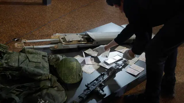 epa12143126 Museum workers handle artefacts of the Russian-Ukrainian war transferred by Ukrainian servicemen to the collection of the Museum of History of Ukraine in WWII during its presentation in Kyiv, Ukraine, 29 May 2025, amid the Russian invasion. Approximately 200 items, including fragments of Russian drones, personal weapons, equipment, sleeve insignia, and awards, were handed over. These artifacts, obtained by servicemen of the 225th Separate Assault Regiment of the Armed Forces of Ukraine during combat with the Russian Army, will become part of the permanent exhibition dedicated to the Russian invasion of Ukraine. EPA/SERGEY DOLZHENKO