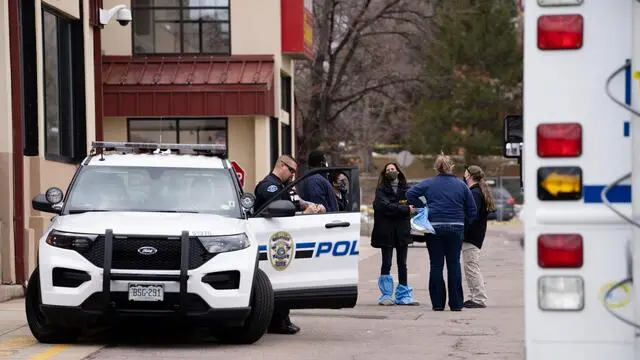 epa09092424 Officials continue to work at the scene a day after Ahmad Al Aliwi Alissa was alleged to have killed ten people including a police officer and is facing ten murder charges at the King Soopers supermarket in Boulder, Colorado, USA, 23 March 2021. Boulder Police released the names of all ten victims as Denny Strong, 20, Neven Stanisic, 23, Rikki Olds, 25, Tralona Bartkowiak, 49, Suzanne Fountain, 59, Teri Leiker, 51, Eric Talley, 51, Kevin Mahoney, 61, Lynn Murray, 62 and Jody Waters, 65. EPA/BRENDAN DAVIS
