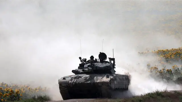 epa11375514 An Israeli tank maneuvers at an undisclosed near the border with the Gaza Strip, in southern Israel, 28 May 2024. More than 36,000 Palestinians and over 1,400 Israelis have been killed, according to the Palestinian Health Ministry and the Israel Defense Forces (IDF), since Hamas militants launched an attack against Israel from the Gaza Strip on 07 October 2023, and the Israeli operations in Gaza and the West Bank which followed it. EPA/ATEF SAFADI