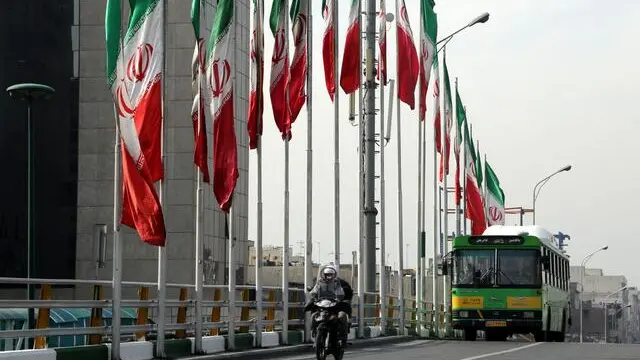 epa04032363 Iran's national flags are displayed on a highway in Tehran, Iran, 20 January 2014. Media reports state that the European Union and the United States are expected on 20 January 2014 to suspend sanctions against Iran for several months, in return for Tehran's scaling back of nuclear enrichment - the first concrete step to address fears that Iran is seeking a nuclear weapon. The carefully choreographed sequence of events begins when inspectors from the International Atomic Energy Association (IAEA) confirm that Tehran is complying with its side of a deal struck in November with Britain, China, France, Germany, Russia and the US. EPA/ABEDIN TAHERKENAREH