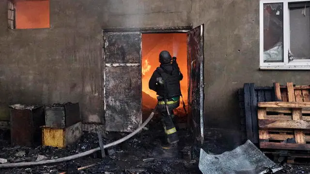 epa12154161 Ukrainian rescuers work at the site of a drone strike in Kharkiv, northeastern Ukraine, 04 June 2025, amid the Russian invasion. At least one person was injured and large-scale fires broke out in industrial zones after Russian forces launched an overnight attack on Kharkiv using nine 'Shahed' drones and two missiles, Kharkiv Mayor Ihor Terekhov wrote on telegram. EPA/SERGEY KOZLOV