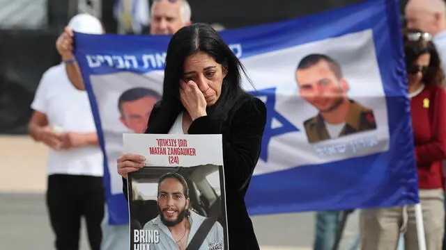 epaselect epa11830475 Einav Zangauker, the mother of Israeli hostage Matan, who was abducted by militants during the 07 October 2023 Hamas attacks, holds a poster of her son reading 'bring him home now!' as family members of Israeli hostages hold a press conference outside the Kirya military headquarters in Tel Aviv, Israel, 17 January 2025. Israel and Hamas have agreed on a hostage release deal and a Gaza ceasefire to be implemented in the coming days following months of war. Israel's security cabinet is expected to meet on 17 January to approve the agreement. EPA/ABIR SULTAN
