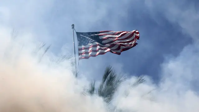 epaselect epa12163105 An American flag is viewed through smoke from flash-bang smoke grenades fired by federal agents as protesters and federal agents clashed near a Home Depot after a raid was conducted by Immigration and Customs Enforcement (ICE) in Paramount, California, USA, 07 June 2025. This comes the day after federal immigration authorities arrested more than 40 people across Los Angeles, as protesters gathered outside a federal detention center. EPA/ALLISON DINNER