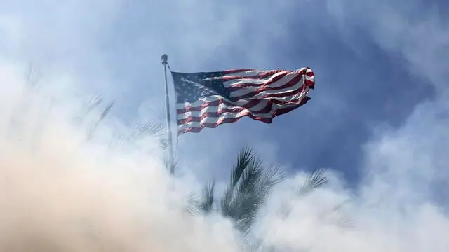 epaselect epa12163105 An American flag is viewed through smoke from flash-bang smoke grenades fired by federal agents as protesters and federal agents clashed near a Home Depot after a raid was conducted by Immigration and Customs Enforcement (ICE) in Paramount, California, USA, 07 June 2025. This comes the day after federal immigration authorities arrested more than 40 people across Los Angeles, as protesters gathered outside a federal detention center. EPA/ALLISON DINNER