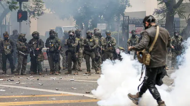 epaselect epa12163077 Federal agents fire flash-bang smoke grenades at protestors near a Home Depot after a raid was conducted by Immigration and Customs Enforcement (ICE) in Paramount, California, USA, 07 June 2025. This comes the day after federal immigration authorities arrested more than 40 people across Los Angeles, as protesters gathered outside a federal detention center. EPA/ALLISON DINNER