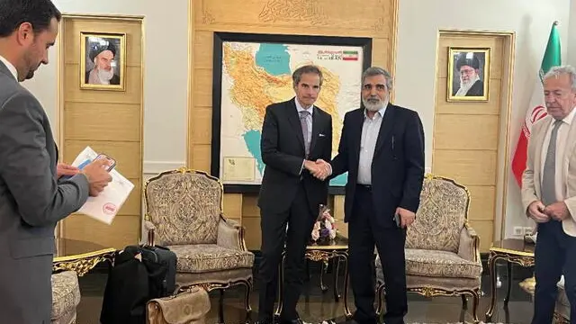 epa12035291 A handout photo made available by the Iranian Atomic Organization (AEOI) office shows International Atomic Energy Agency (IAEA) Director General Rafael Grossi (L) and Atomic Energy Organization of Iran (AEOI) spokesman Behrouz Kamalvandi (R) shakes hands upon Grossi's arrival in Tehran, Iran, 16 April 2025. Grossi is in Tehran to meet with Iranian officials following Iran and US nuclear talks. EPA/IRAN ATOMIC ORGANIZATION / HANDOUT HANDOUT EDITORIAL USE ONLY/NO SALES
