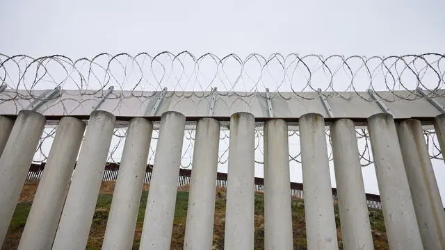 epa12156178 Razor wire is installed along the US southern border wall with Mexico to deter illegal crossings in San Diego, California, USA, 04 June 2025. EPA/ALLISON DINNER