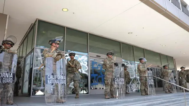 epa12167028 Members of the California National Guard stationed in front of the Edward R. Roybal Federal Building in Los Angeles, California, USA, 09 June 2025. Approximately 2,000 National Guard troops were deployed on 08 June in Los Angeles by US President Donald Trump, though the state of California had not requested any additional assistance, and protests have continued against the Trump administration's immigration enforcement raids over the last couple of days. EPA/ALLISON DINNER