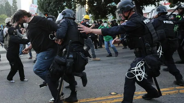 epaselect epa12167306 Police detain a protester as they clash in Los Angeles, California, USA, 09 June 2025. Approximately 2,000 National Guard troops were deployed on 08 June in Los Angeles by US President Donald Trump, though the state of California had not requested any additional assistance, and protests have continued against the Trump administration's immigration enforcement raids over the last couple of days. EPA/ALLISON DINNER