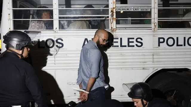 epa12167384 Los Angeles police officers detain individuals following clashes with protesters in Los Angeles, California, USA, 09 June 2025. US President Donald Trump has deployed 2,000 National Guard troops, despite not receiving a request from the state of California for any additional assistance, following large protests against ongoing immigration enforcement raids in the Los Angeles area over the last couple of days. EPA/CAROLINE BREHMAN