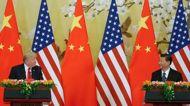 epa06317022 Chinese President Xi Jinping (R) listens to US President Donald J. Trump (L) during a press conference at the Great Hall of the People (GHOP) in Beijing, China, 09 November 2017. Trump is on an official visit to China from 08 to 10 November as part of his 12-day tour of Asia. EPA/ROMAN PILIPEY