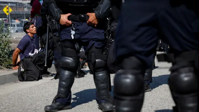 epa12169432 A protestor is detained during protests sparked by immigration raids in Los Angeles, California, USA, 10 June 2025. US President Donald Trump has deployed 2,000 National Guard troops, despite not receiving a request from the state of California for any additional assistance, following large protests against ongoing immigration enforcement raids in the Los Angeles area over the last few days. EPA/CAROLINE BREHMAN
