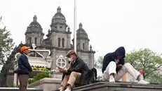 epa12044407 People sit outside the St. Joseph's Catholic Church following the death of Pope Francis, Beijing, China, 21 April 2025. Pope Francis died on 21 April 2025 at the age of 88, according to the Holy See. Born Jorge Mario Bergoglio in Buenos Aires, Argentina, on 17 December 1936, he was appointed leader of the Catholic Church on 13 March 2013, succeeding Pontiff Emeritus Benedict XVI. EPA/WU HAO