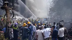 epa12171197 Firefighters work at the site of a plane crash near Sardar Vallabhbhai Patel International Airport in Ahmedabad, Gujarat, western India, 12 June 2025. Air India flight AI171, bound for London carrying 242 passengers and crew members on board a Boeing 787-8 aircraft, crashed minutes after take-off in the Meghaninagar area of Ahmedabad. EPA/SIDDHARAJ SOLANKI