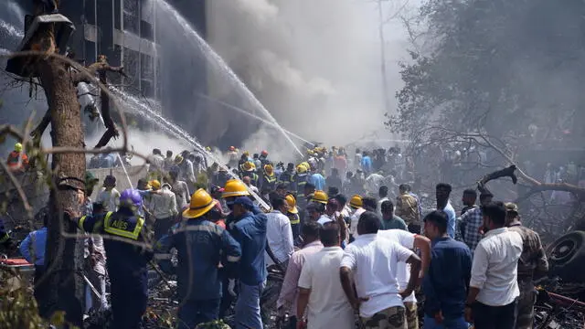 epa12171197 Firefighters work at the site of a plane crash near Sardar Vallabhbhai Patel International Airport in Ahmedabad, Gujarat, western India, 12 June 2025. Air India flight AI171, bound for London carrying 242 passengers and crew members on board a Boeing 787-8 aircraft, crashed minutes after take-off in the Meghaninagar area of Ahmedabad. EPA/SIDDHARAJ SOLANKI