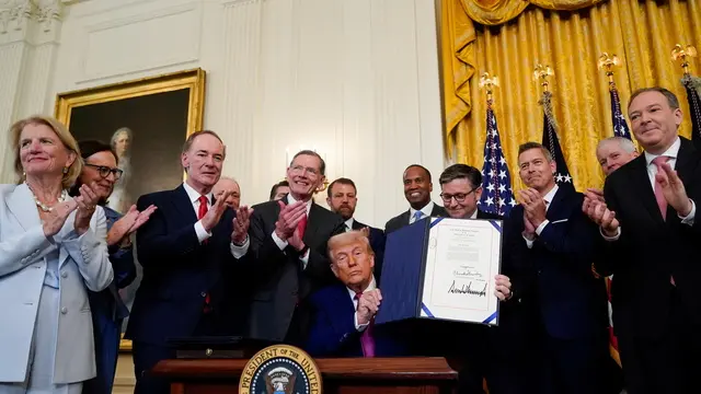 epa12171832 US President Donald Trump (C) displays a signed bill during a ceremony in the East Room of the White House in Washington, DC, USA, 12 June 2025. EPA/ALEXANDER DRAGO / POOL