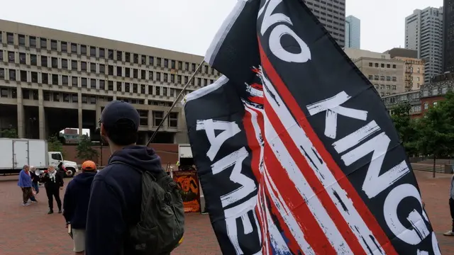 epa12167136 A man carries a flag that reads 'No Kings in America,' while he and local union members attend a rally in support of union leader David Huerta and the protesters in Los Angeles, on the Boston City Hall Plaza in Boston, Massachusetts, USA, 09 June 2025. Huerta who was detained in Los Angeles, seen injured on television on 06 June 2025, was arrested while protesting a raid by Immigration and Customs Enforcement (ICE) division of the US Department of Homeland Security at a worksite in downtown Los Angeles and was accused of obstructing police officers. EPA/CJ GUNTHER