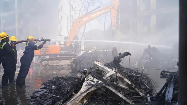 epa12171314 Firefighters work at the site of a plane crash near Sardar Vallabhbhai Patel International Airport in Ahmedabad, Gujarat, western India, 12 June 2025. Air India flight AI171, bound for London carrying 242 passengers and crew members on board a Boeing 787-8 aircraft, crashed minutes after take-off in the Meghaninagar area of Ahmedabad. EPA/SIDDHARAJ SOLANKI