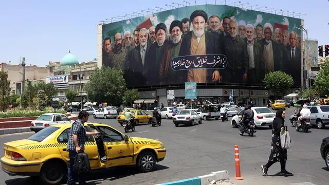 epa12152296 A huge billboard carrying picture of Iranian late supreme leader Ayatollah Ruhollah Khomeini (C) along with Iranians, Lebanese and Hamas late leaders, and a sentence reading in Persian 'The spirit of God has been breathed into the noblest of creatures' is seen on the occasion of 36th anniversary of Ayatollah Khomeini's death, in Tehran, Iran, 03 June 2025. Iran will celebrate 36th anniversary of Ayatollah Khomeini's death on 04 June 2025. EPA/ABEDIN TAHERKENAREH