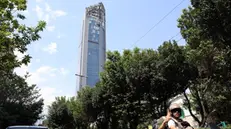 epa12173185 People pass by a damaged high-rise building that was hit by Israeli air strikes, north of Tehran, Iran, 13 June 2025. Israel launched strikes on Iran and its capital Tehran early 13 June, killing top military figures, including Armed Forces Chiefs of Staff Mohammad Bagheri and Chief Commander of the Islamic Revolutionary Guard Corps (IRGC) Hossein Salami, both countries confirmed. The strikes were part of Operation Rising Lion, Israel's Prime Minister Netanyahu said, adding that Iran's nuclear programme poses a threat to 'Israel's very survival.' EPA/ABEDIN TAHERKENAREH