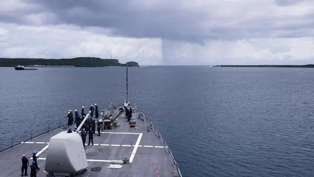 epa06802627 A handout photo made available by the US Navy on 12 June 2018 shows the Arleigh Burke-class guided-missile destroyer USS Benfold (DDG 65) departing from Apra Harbor, Guam, 11 June 2018, for the at-sea portion of Exercise Malabar 2018. Malabar 2018 is designed to advance military-to-military coordination in a multinational environment between the US, Japan and Indian maritime forces. EPA/US NAVY/MC2 ANNA VAN NUYS HANDOUT HANDOUT EDITORIAL USE ONLY/NO SALES
