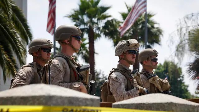 epa12174316 US Marine service members guard a checkpoint at the Wilshire Federal Building in Los Angeles, California, USA, 13 June 2025. US Marines arrived at a federal office building in Los Angeles as they began to take over guard duty as part of the Trump administration’s response to protests over the deportation of immigrants. EPA/CAROLINE BREHMAN