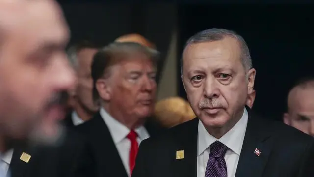 epa08043531 Turkey President Recep Tayyip Erdogan and US President Donald Trump (back) during NATO Summit in London, Britain, 04 December 2019. NATO countries' heads of states and governments gather in London for a two-day meeting. EPA/OLIVIER HOSLET