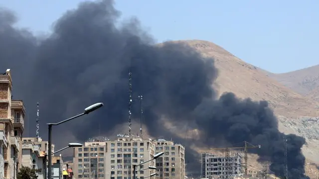epa12178548 Smoke rises from an oil refinery, northwest of Tehran, Iran, 16 June 2025. Israel and Iran have been exchanging fire since Israel launched strikes across Iran on 13 June 2025 as part of Operation 'Rising Lion.' EPA/ABEDIN TAHERKENAREH