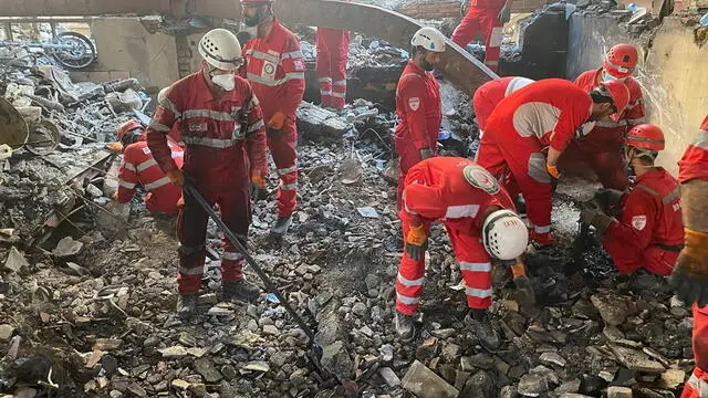 epa12180430 A handout photo made available by Iranian Red Crescent Society (IRCS) shows rescuers working at the site of an airstrike on a residential area in Tehran, Iran, 17 June 2025. Israel has continued its strikes across Iran since 13 June, targeting nuclear and energy facilities, and a state television building in Tehran. In response, Iran launched waves of retaliatory missiles and drones toward Israel. EPA/IRANIAN RED CRESCENT SOCIETY HANDOUT -- MANDATORY CREDIT -- BEST QUALITY AVAILABLE -- HANDOUT EDITORIAL USE ONLY/NO SALES