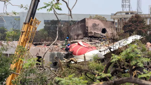 epa12174658 Officials inspect the remains of the Air India passenger plane at the crash site near Sardar Vallabhbhai Patel International Airport in Ahmedabad, Gujarat state, western India, 14 June 2025. Air India flight AI171, bound for London carrying 242 passengers and crew members on board a Boeing 787-8 aircraft, crashed minutes after take-off in the Meghaninagar area of Ahmedabad on 12 June. EPA/RAJAT GUPTA