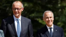 epa12179620 German Chancellor Friedrich Merz (L) and Canadian Prime Minister Mark Carney take part in an arrival ceremony at the Group of Seven (G7) Summit at the Pomeroy Kananaskis Mountain Lodge, in Kananaskis, Alberta, Canada, 16 June 2025. EPA/LUDOVIC MARIN / POOL