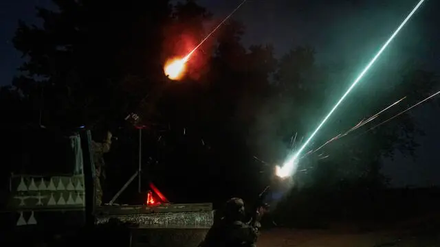 epa12180583 Ukrainian servicemen of a unit of the Volunteer Formation of the United Territorial Community (DFTG) shoot at drones flying towards Kyiv, Ukraine, 17 June 2025. The volunteers are firing with a Browning M2 machine gun and a Kalashnikov rifle and shot down at least one target during the night, the DFTG said. At least 14 people died and more than 60 were injured in Kyiv after Russia launched a large-scale combined attack with at least 32 missiles and nearly 440 drones across Ukraine, according to the State Emergency Service. EPA/STAS KOZLIUK