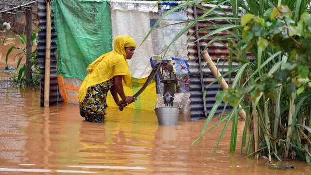 epa12149119 A woman collects drinking water amid the floods in Nagaon district of Assam, India, 01 June 2025. At least 25 people have been killed across north-east India following days of relentless monsoon rains that triggered widespread landslides and flash floods, officials have confirmed. In Assam, heavy rain continues to batter several parts of the state. According to the Assam State Disaster Management Authority (ASDMA), the districts worst affected include Dhemaji, South Salmara, Lakhimpur, Dibrugarh, Golaghat, Darrang, Nagaon, Karbi Anglong, Kamrup, Biswanath, Tinsukia and West Karbi Anglong. EPA/ANUWAR ALI HAZARIKA