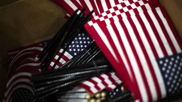 epa07593219 A cardboard box containing small American flags sits next to the entrance during a naturalization ceremony at a convention center in Los Angeles, California, USA, 22 May 2019. More than 6,000 new US citizen were naturalized today by the US Citizenship and Immigration Services (USCIS) in Los Angeles. In 2018, the United States naturalized 750,000 people nationwide. EPA/ETIENNE LAURENT