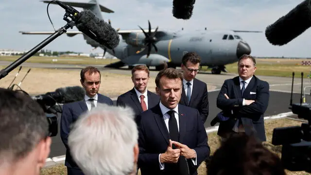 epa12186852 French President Emmanuel Macron (C), flanked by (L-R) French Minister for Industry and Energy Marc Ferracci, French Minister in charge of Higher Education and Research Philippe Baptiste and French Minister for Transport Philippe Tabarot, talks to journalists after disembarking from an Airbus A400M military plane for a visit at the 55th edition of the International Paris Air Show at the Paris-Le Bourget Airport, in Le Bourget, near Paris, France, 20 June 2025. The Paris Air Show, one of the largest trade fairs of the aerospace-industry and air shows in the world, runs from 16 to 22 June. EPA/BENOIT TESSIER / POOL MAXPPP OUT