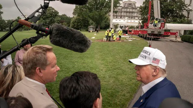 epa12183692 U.S. President Donald Trump speaks to the press while workers instals a new flagpole on the South Lawn at the White House in Washington, DC, USA, 18 June 2025. EPA/KEN CEDENO / POOL
